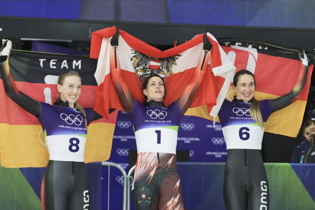 (260215) -- CORTINA D'AMPEZZO, Feb. 15, 2026 (Xinhua) -- Gold medalist Janine Flock (C) of Austria, silver medalist Susanne Kreher (L) of Germany and bronze medalist Jacqueline Pfeifer of Germany celebrate after the skeleton women's heat at the Milan-Cortina 2026 Olympic Winter Games in Cortina, Italy, Feb. 14, 2026. (Xinhua/Ding Xu)