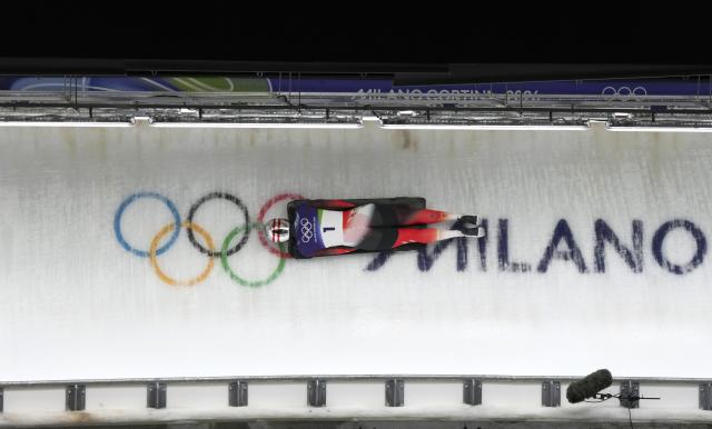 (260215) -- CORTINA D'AMPEZZO, Feb. 15, 2026 (Xinhua) -- Janine Flock of Austria competes during the skeleton women's heat at the Milan-Cortina 2026 Olympic Winter Games in Cortina, Italy, Feb. 14, 2026. (Xinhua/Li Gang)