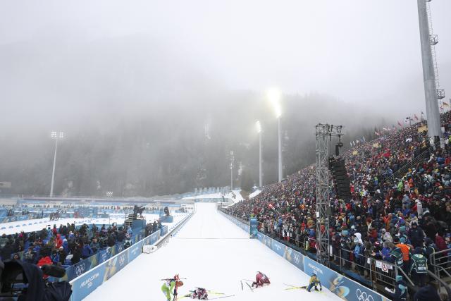 (260215) -- ANTERSELVA, Feb. 15, 2026 (Xinhua) -- Athletes rest after crossing the finish line during the biathlon women's 7.5km sprint event at the Milan-Cortina 2026 Olympic Winter Games in Anterselva, Italy, Feb. 14, 2026. (Xinhua/Zhang Tao)