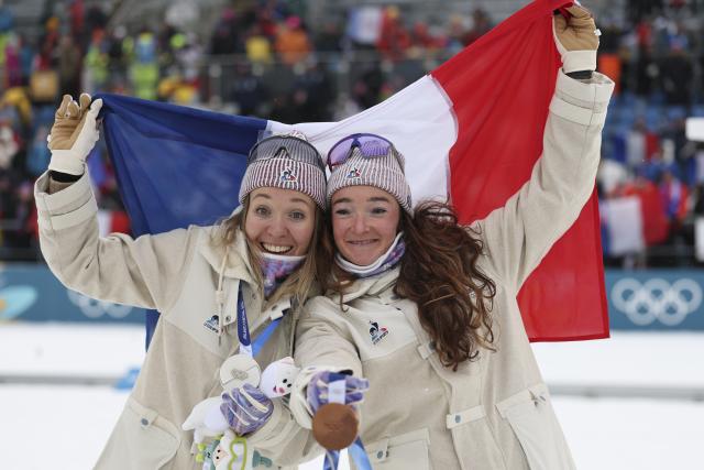 (260215) -- ANTERSELVA, Feb. 15, 2026 (Xinhua) -- Silver medalist Oceane Michelon (L) of France and her teammate bronze medalist Lou Jeanmonnot pose during the awarding ceremony of the biathlon women's 7.5km sprint event at the Milan-Cortina 2026 Olympic Winter Games in Anterselva, Italy, Feb. 14, 2026. (Xinhua/Zhang Tao)