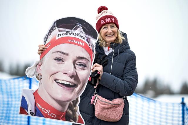 (260215) -- ANTERSELVA, Feb. 15, 2026 (Xinhua) -- A spectator holds a board of Switzerland's Amy Baserga before the biathlon women's 7.5km sprint event at the Milan-Cortina 2026 Olympic Winter Games in Anterselva, Italy, Feb. 14, 2026. (Xinhua/Jiang Han)