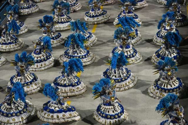 (260215) -- RIO DE JANEIRO, Feb. 15, 2026 (Xinhua) -- Samba dancers perform in a parade during the Carnival 2026 in Rio de Janeiro, Brazil, Feb. 14, 2026. Brazil kicked off its most emblematic celebration this weekend as Carnival festivities fill streets, sambadromes and public squares across the country with music, dance and millions of revelers. (Photo by Lucio Tavora/Xinhua)