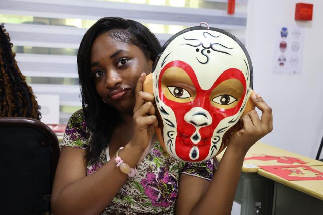(260215) -- ACCRA, Feb. 15, 2026 (Xinhua) -- A student poses for photos with a mask in Accra, Ghana, Feb. 13, 2026. The Confucius Institute at the University of Ghana on Friday held a New Year garden party for Ghanaian students ahead of the Chinese Spring Festival, offering a lively introduction to Chinese culture. (Photo by Seth/Xinhua)