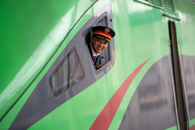 (260215) -- LHASA, Feb. 15, 2026 (Xinhua) -- Sonam Wangdrak poses for a photo with a Fuxing high-speed train in Lhasa, southwest China's Xizang Autonomous Region, Feb. 14, 2026.
  This year marks Sonam Wangdrak's 19th year in railway service and his 19th Spring Festival travel rush. 
   As the peak travel period approaches, Sonam Wangdrak and his colleagues remain dedicated to their posts, ensuring the safe journey of every passenger. (Xinhua/Tenzing Nima Qadhup)
