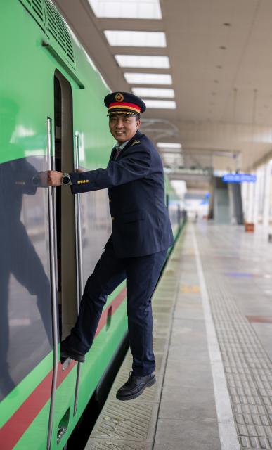 (260215) -- LHASA, Feb. 15, 2026 (Xinhua) -- Sonam Wangdrak poses for a photo with a Fuxing high-speed train in Lhasa, southwest China's Xizang Autonomous Region, Feb. 14, 2026.
  This year marks Sonam Wangdrak's 19th year in railway service and his 19th Spring Festival travel rush. 
   As the peak travel period approaches, Sonam Wangdrak and his colleagues remain dedicated to their posts, ensuring the safe journey of every passenger. (Xinhua/Tenzing Nima Qadhup)