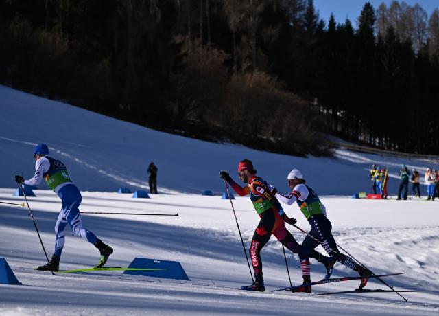 (260215) -- TESERO, Feb. 15, 2026 (Xinhua) -- Livo Niskanen (L) of Finland, Antoine Cyr (C) of Canada and Gus Schumacher of the United States compete during the cross-country skiing men's 4X7.5km relay match at the Milan-Cortina 2026 Olympic Winter Games in Tesero, Italy, Feb. 15, 2026. (Xinhua/He Canling)