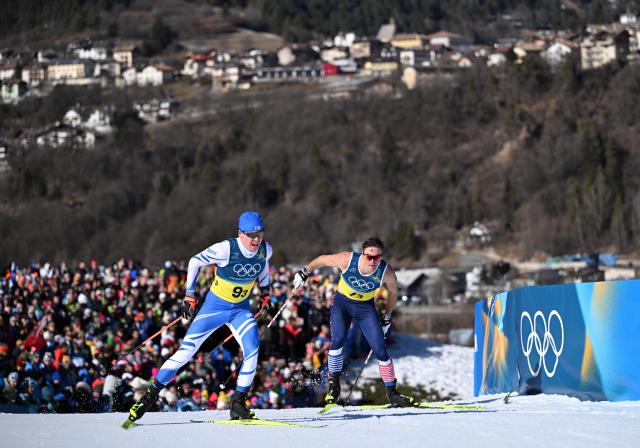 (260215) -- TESERO, Feb. 15, 2026 (Xinhua) -- Arsi Ruuskanen (L) of Finland and John Steel Hagenbuch of the United States compete during the cross-country skiing men's 4X7.5km relay match at the Milan-Cortina 2026 Olympic Winter Games in Tesero, Italy, Feb. 15, 2026. (Xinhua/He Canling)