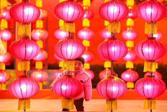 (260215) -- BEIJING, Feb. 15, 2026 (Xinhua) -- A child plays at a square in Jingning County, northwest China's Gansu Province, Feb. 13, 2026. China is alive with vibrant celebrations with the Spring Festival just around the corner. (Photo by Hou Chonghui/Xinhua)