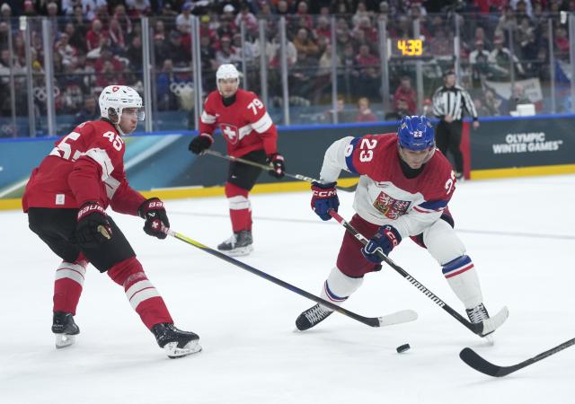 (260215) -- MILAN, Feb. 15, 2026 (Xinhua) -- Lukas Sedlak (R) of the Czech Republic and Michael Fora of Switzerland battle for the puck during the ice hockey men's preliminary round group A match between Switzerland and the Czech Republic of the Milan-Cortina 2026 Olympic Winter Games in Milan, Italy, Feb. 15, 2026. (Xinhua/Tao Xiyi)