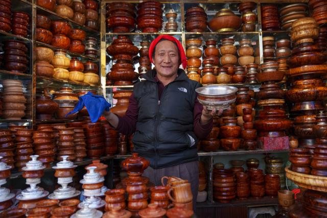 (260215) -- LHASA, Feb. 15, 2026 (Xinhua) -- A vendor presents goods at a market in Lhasa, southwest China's Xizang Autonomous Region, Feb. 15, 2026. With the Spring Festival and the Tibetan New Year right around the corner, market places in Lhasa receive a surge of customers buying goods needed for the holidays. (Xinhua/Tenzin Nyida)