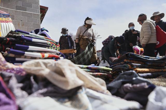 (260215) -- LHASA, Feb. 15, 2026 (Xinhua) -- People shop at a market in Lhasa, southwest China's Xizang Autonomous Region, Feb. 15, 2026. With the Spring Festival and the Tibetan New Year right around the corner, market places in Lhasa receive a surge of customers buying goods needed for the holidays. (Xinhua/Zhang Licong)