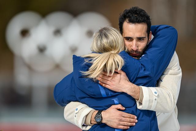 (260215) -- ANTERSELVA, Feb. 15, 2026 (Xinhua) -- Martin Fourcade (R) of France, gold medalist for the biathlon men's 15km mass start from the 2010 Vancouver Winter Olympics, hugs International Olympic Committee (IOC) President Kirsty Coventry during a reallocation medals ceremony at the 2026 Winter Olympics in Anterselva, Italy, Feb. 15, 2026. (Xinhua/Jiang Han)