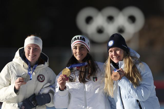 (260215) -- ANTERSELVA), Feb. 15, 2026 (Xinhua) -- Gold medalist Lisa Vittozzi (C) of Italy, silver medalist Maren Kirkeeide (L) of Norway and bronze medalist Suvi Minkkinen of Finland pose for photos during the awarding ceremony of the biathlon women's 10km pursuit at the 2026 Milan-Cortina Winter Olympics in Anterselva, Italy, Feb. 15, 2026. (Xinhua/Zhang Tao)