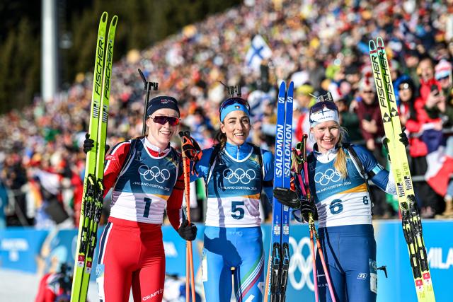 (260215) -- ANTERSELVA, Feb. 15, 2026 (Xinhua) -- Gold medalist Lisa Vittozzi (C) of Italy, silver medalist Maren Kirkeeide (L) of Norway and bronze medalist Suvi Minkkinen of Finland pose for photos after the biathlon women's 10km pursuit at the 2026 Milan-Cortina Winter Olympics in Anterselva, Italy, Feb. 15, 2026. (Xinhua/Jiang Han)
