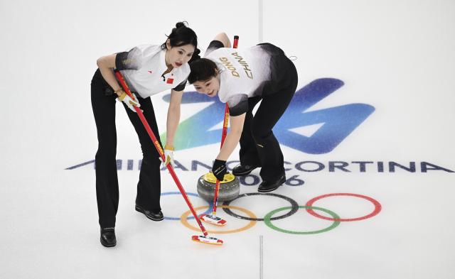 (260215) -- CORTINA D'AMPEZZO, Feb. 15, 2026 (Xinhua) -- Jiang Jiayi (L) and Dong Ziqi of China compete during the curling women round robin session 6 match between China and the United States at the 2026 Milan-Cortina Winter Olympics in Cortina, Italy, Feb. 15, 2026. (Xinhua/Lian Yi)