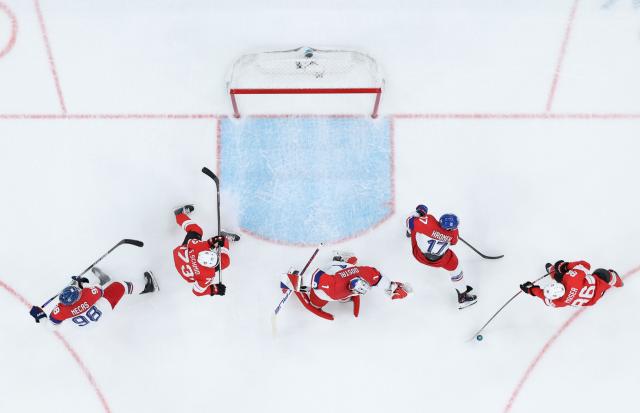 (260215) -- MILAN, Feb. 15, 2026 (Xinhua) -- Janis Moser (1st R) of Switzerland competes during the ice hockey men's preliminary round group A match between Switzerland and the Czech Republic of the Milan-Cortina 2026 Olympic Winter Games in Milan, Italy, Feb. 15, 2026. (Xinhua/Tao Xiyi)