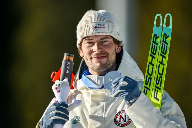 (260215) -- ANTERSELVA, Feb. 15, 2026 (Xinhua) -- Silver medalist Sturla Holm Laegreid of Norway poses for photos during the awarding ceremony of the biathlon men's 12.5km pursuit at the 2026 Milan-Cortina Winter Olympics in Anterselva, Italy, Feb. 15, 2026. (Xinhua/Jiang Han)