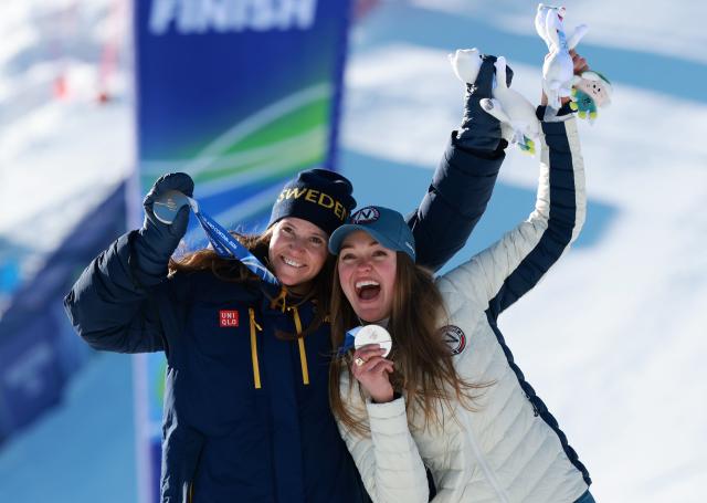 (260215) -- CORTINA D'AMPEZZO, Feb. 15, 2026 (Xinhua) -- Silver medalists Sara Hector (L) of Sweden and Thea Louise Stjernesund of Norway celebrate during the awarding ceremony of the alpine skiing women's giant slalom at the Milan-Cortina 2026 Olympic Winter Games in Cortina, Italy, Feb. 15, 2026. (Xinhua/Zhang Chenlin)