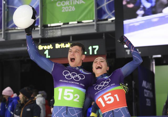 (260215) -- CORTINA D'AMPEZZO, Feb. 15, 2026 (Xinhua) -- Tabitha Stoecker (R)/Matt Weston of Britain celebrate after the skeleton mixed team competition at the Milan-Cortina 2026 Olympic Winter Games in Cortina, Italy, Feb. 15, 2026. (Xinhua/Ding Xu)