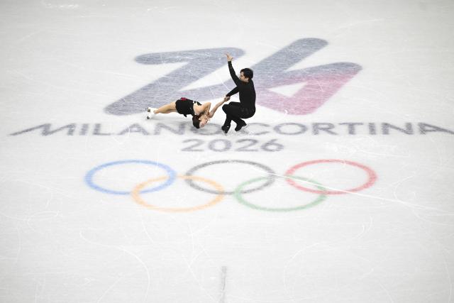 (260215) -- MILAN, Feb. 15, 2026 (Xinhua) -- Sui Wenjing (L)/Han Cong compete during the figure skating pair skating short program match at the Milan-Cortina 2026 Olympic Winter Games in Milan, Italy, Feb. 15, 2026. (Xinhua/Cheng Min)