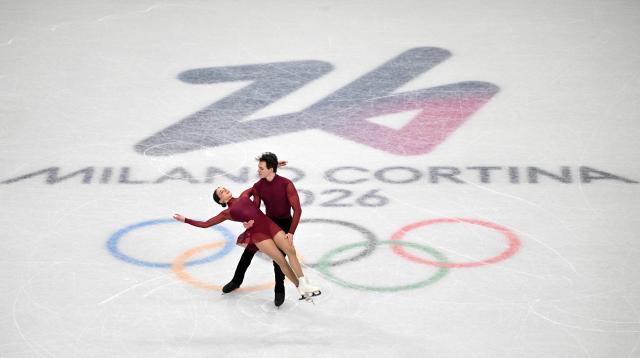 (260216) -- MILAN, Feb. 16, 2026 (Xinhua) -- Maria Pavlova and Alexei Sviatchenko of Hungary perform during the figure skating pair skating short program match at the Milan-Cortina 2026 Olympic Winter Games in Milan, Italy, Feb. 15, 2026. (Xinhua/Cheng Min)