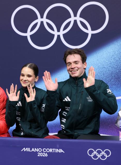 (260216) -- MILAN, Feb. 16, 2026 (Xinhua) -- Maria Pavlova of Hungary and Alexei Sviatchenko of Hungary wait for the score after their performance during the figure skating pair skating short program match at the Milan-Cortina 2026 Olympic Winter Games in Milan, Italy, Feb. 15, 2026. (Xinhua/Chen Yichen)