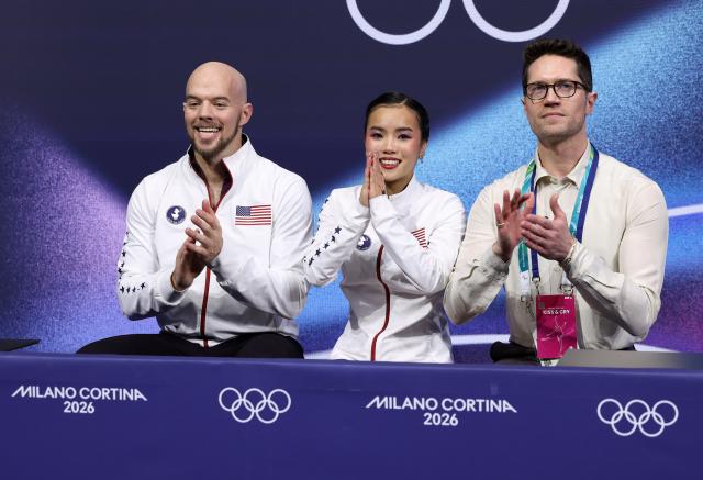 (260216) -- MILAN, Feb. 16, 2026 (Xinhua) -- Ellie Kam and Danny O'Shea of the United States wait for the score after their performance during the figure skating pair skating short program match at the Milan-Cortina 2026 Olympic Winter Games in Milan, Italy, Feb. 15, 2026. (Xinhua/Chen Yichen)