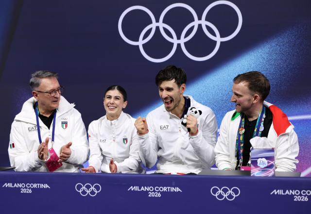 (260216) -- MILAN, Feb. 16, 2026 (Xinhua) -- Rebecca Ghilardi and Filippo Ambrosini of Italy wait for the score after their performance during the figure skating pair skating short program match at the Milan-Cortina 2026 Olympic Winter Games in Milan, Italy, Feb. 15, 2026. (Xinhua/Chen Yichen)