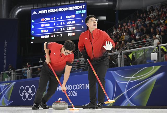 (260216) -- CORTINA D'AMPEZZO, Feb. 16, 2026 (Xinhua) -- Li Zhichao (L) and Xu Jingtao of China compete during the curling men round robin session 7 match between China and Canada at the 2026 Milan-Cortina Winter Olympics in Cortina, Italy, Feb. 15, 2026. (Xinhua/Lian Yi)