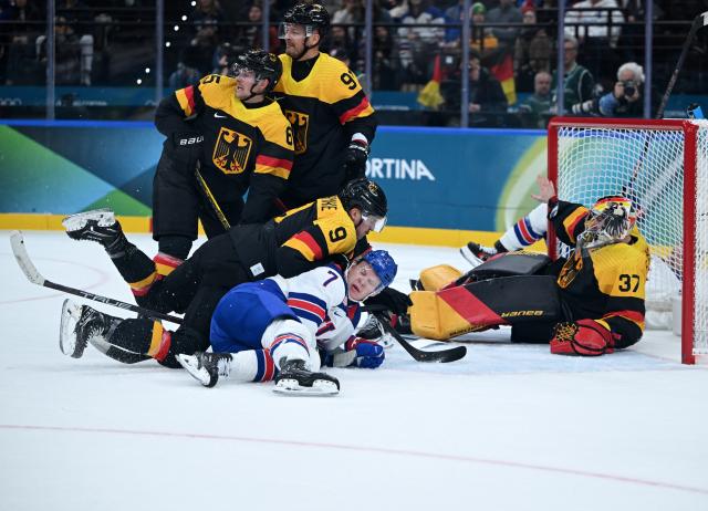 (260216) -- MILAN, Feb. 16, 2026 (Xinhua) -- Brady Tkachuk (bottom) of the United States falls during the ice hockey men's preliminary round group C match between the United States and Germany at the Milan-Cortina 2026 Olympic Winter Games in Milan, Italy, Feb. 15, 2026. (Xinhua/Zhang Haofu)