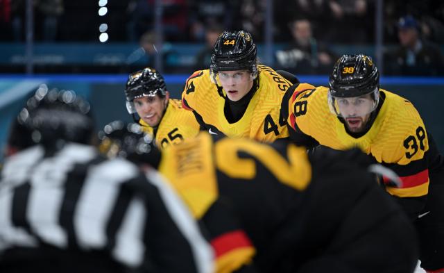 (260216) -- MILAN, Feb. 16, 2026 (Xinhua) -- Joshua Samanski (C) and Fabio Wagner (R) of Germany are seen during the ice hockey men's preliminary round group C match between the United States and Germany at the Milan-Cortina 2026 Olympic Winter Games in Milan, Italy, Feb. 15, 2026. (Xinhua/Zhang Haofu)