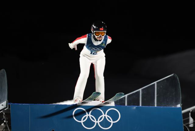 (260216) -- PREDAZZO, Feb. 16, 2026 (Xinhua) -- Liu Qi of China competes during the first round of ski jumping women's large hill individual event at the Milan-Cortina 2026 Olympic Winter Games in Predazzo, Italy, Feb. 15, 2026. (Xinhua/Huang Wei)