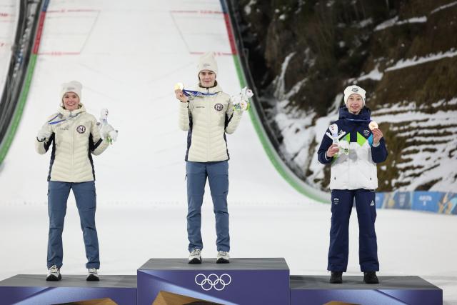 (260216) -- PREDAZZO, Feb. 16, 2026 (Xinhua) -- Silver medallist Norway's Eirin Maria Kvandal, gold medallist Norway's Anna Odine Stroem and bronze medallist Slovenia's Nika Prevc (L to R) celebrate on the podium for of ski jumping women's large hill individual event at the Milan-Cortina 2026 Olympic Winter Games in Predazzo, Italy, Feb. 15, 2026. (Xinhua/Huang Wei)