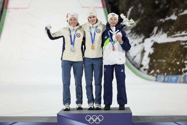 (260216) -- PREDAZZO, Feb. 16, 2026 (Xinhua) -- Silver medallist Norway's Eirin Maria Kvandal, gold medallist Norway's Anna Odine Stroem and bronze medallist Slovenia's Nika Prevc (L to R) celebrate on the podium for of ski jumping women's large hill individual event at the Milan-Cortina 2026 Olympic Winter Games in Predazzo, Italy, Feb. 15, 2026. (Xinhua/Huang Wei)