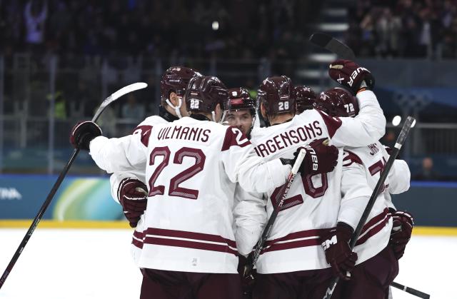 (260216) -- MILAN, Feb. 16, 2026 (Xinhua) -- Players of Latvia celebrate during the ice hockey men's preliminary round group C match between Denmark and Latvia at the Milan-Cortina 2026 Olympic Winter Games in Milan, Italy, Feb. 15, 2026. (Xinhua/Wang Kaiyan)