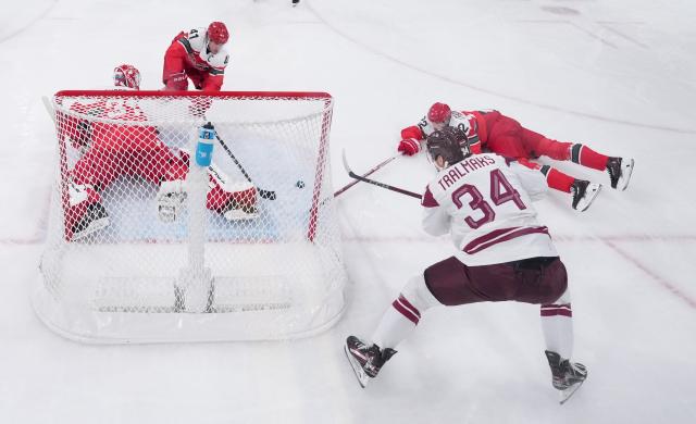 (260216) -- MILAN, Feb. 16, 2026 (Xinhua) -- Players compete during the ice hockey men's preliminary round group C match between Denmark and Latvia of the Milan-Cortina 2026 Olympic Winter Games in Milan, Italy, Feb. 15, 2026. (Wang Kaiyan/Pool via Xinhua)