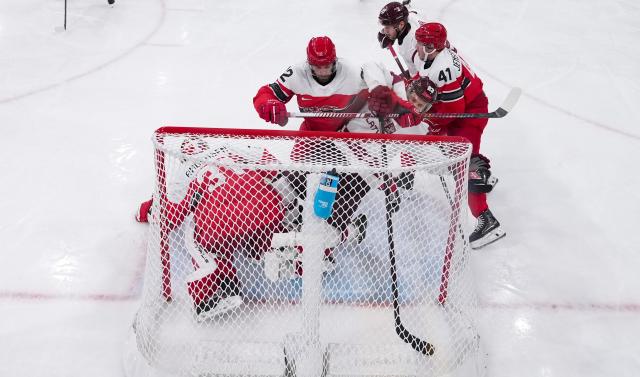 (260216) -- MILAN, Feb. 16, 2026 (Xinhua) -- Players compete during the ice hockey men's preliminary round group C match between Denmark and Latvia of the Milan-Cortina 2026 Olympic Winter Games in Milan, Italy, Feb. 15, 2026. (Wang Kaiyan/Pool via Xinhua)