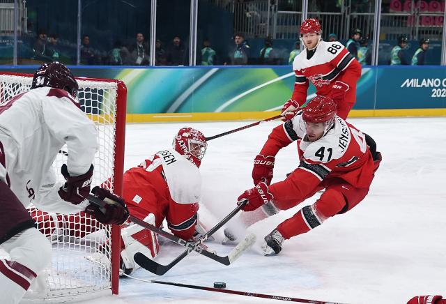 (260216) -- MILAN, Feb. 16, 2026 (Xinhua) -- Jesper Jensen Aabo (R, bottom) of Denmark competes during the ice hockey men's preliminary round group C match between Denmark and Latvia at the Milan-Cortina 2026 Olympic Winter Games in Milan, Italy, Feb. 15, 2026. (Xinhua/Wang Kaiyan)