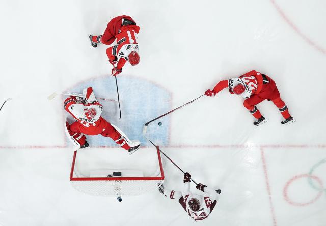 (260216) -- MILAN, Feb. 16, 2026 (Xinhua) -- Players compete during the ice hockey men's preliminary round group C match between Denmark and Latvia at the Milan-Cortina 2026 Olympic Winter Games in Milan, Italy, Feb. 15, 2026. (Xinhua/Wang Kaiyan)