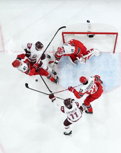 (260216) -- MILAN, Feb. 16, 2026 (Xinhua) -- Players compete during the ice hockey men's preliminary round group C match between Denmark and Latvia at the Milan-Cortina 2026 Olympic Winter Games in Milan, Italy, Feb. 15, 2026. (Xinhua/Wang Kaiyan)