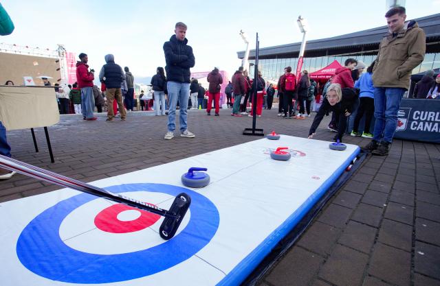 (260216) -- VANCOUVER, Feb. 16, 2026 (Xinhua) -- People play a curling game during the Team Canada Fanfest in Vancouver, Canada, on Feb. 15, 2026. The event is part of a nationwide FanFest series planned for Canadian cities during 2026 Milan-Cortina Winter Olympics. (Photo by Liang Sen/Xinhua)