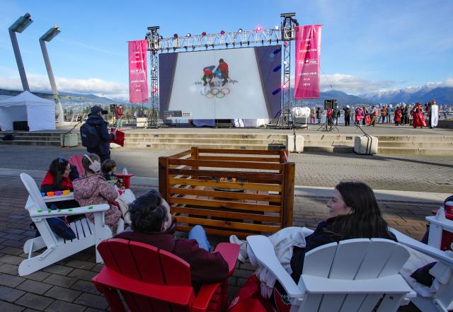 (260216) -- VANCOUVER, Feb. 16, 2026 (Xinhua) -- People watch live Winter Olympic competitions on a big screen during the Team Canada Fanfest in Vancouver, Canada, on Feb. 15, 2026. The event is part of a nationwide FanFest series planned for Canadian cities during 2026 Milan-Cortina Winter Olympics. (Photo by Liang Sen/Xinhua)