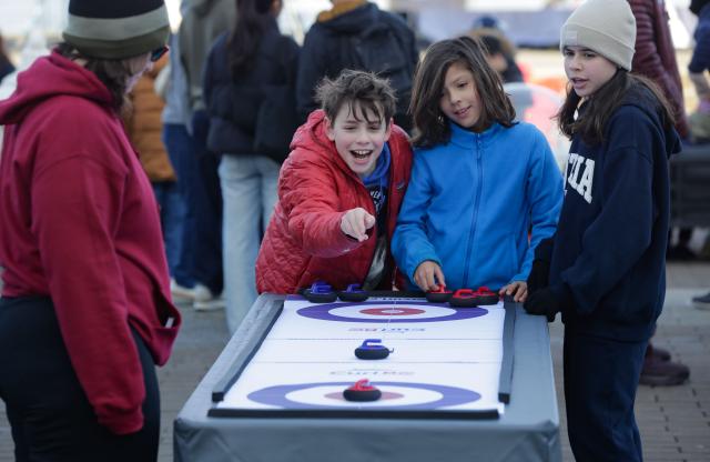 (260216) -- VANCOUVER, Feb. 16, 2026 (Xinhua) -- Children play a table hockey game during the Team Canada Fanfest in Vancouver, Canada, on Feb. 15, 2026. The event is part of a nationwide FanFest series planned for Canadian cities during 2026 Milan-Cortina Winter Olympics. (Photo by Liang Sen/Xinhua)