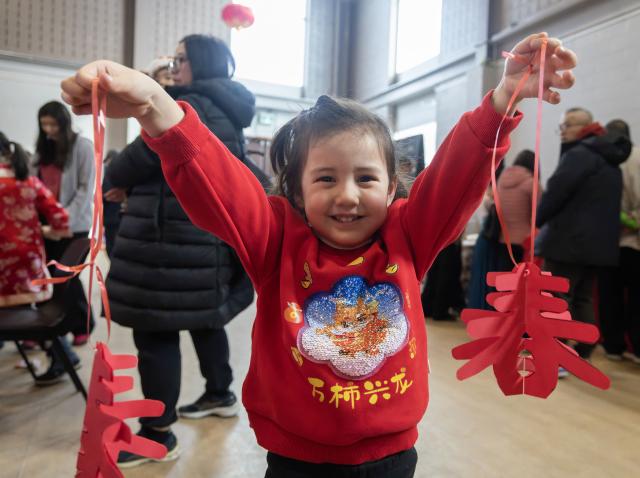 (260216) -- TORONTO, Feb. 16, 2026 (Xinhua) -- A girl poses for photos with her paper-cutting works in celebration of Chinese New Year at the Chinese Cultural Center of Greater Toronto in Toronto, Canada, Feb. 15, 2026. (Photo by Zou Zheng/Xinhua)