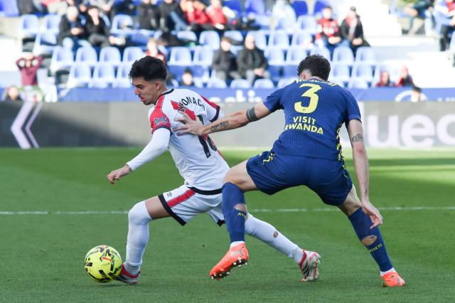 (260216) -- MADRID, Feb. 16, 2026 (Xinhua) -- Ilias Akhomach (L) of Vallecano vies with Matteo Ruggeri of Atletico de Madrid during the La Liga football match between Rayo Vallecano and Atletico de Madrid in Madrid, Spain, Feb. 15, 2026. (Photo by Gustavo Valiente/Xinhua)