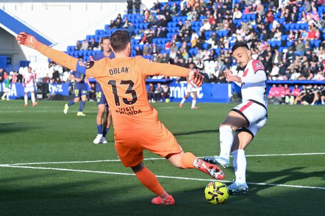 (260216) -- MADRID, Feb. 16, 2026 (Xinhua) -- Alvaro Garcia (R) of Vallecano vies with Jan Oblak of Atletico de Madrid during the La Liga football match between Rayo Vallecano and Atletico de Madrid in Madrid, Spain, Feb. 15, 2026. (Photo by Gustavo Valiente/Xinhua)