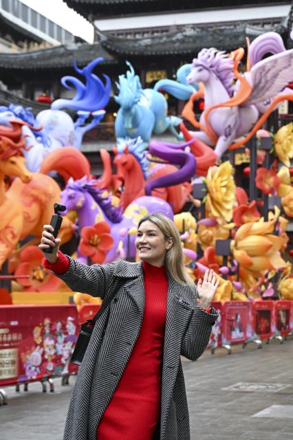 (260216) -- SHANGHAI, Feb. 16, 2026 (Xinhua) -- Aleksandra Antonenko takes short videos at Yuyuan Garden shopping mall in Shanghai, east China, Feb. 6, 2026.
  Aleksandra Antonenko moved from Russia to pursue her doctorate at Shanghai Jiao Tong University in 2022. She also began to show the charm of everyday life in China to the world with short video clips. 
  In the same year, she met Zhao Yiwei, now her husband, at a coffee shop. Zhao always encourages and supports her diligence, be it in academic pursue or in vlog production.
  With the Spring Festival around the corner, Aleksandra loves wandering through streets and picking out New Year goods. Back to her home, she adds her own tradition to the celebration by cooking Russian dishes for the holiday, turning the table into a blend of two cultures. 
  "The Spring Festival has deep cultural roots," Aleksandra said. "It's a time to bring family together and feel closer."
  Looking ahead, she plans to keep working toward her doctoral degree while continuing to document her life in China through videos. "Every day here brings something new," she said. "I'm excited to share real stories about China with the world."
  From a newbie international student to a Chinese daughter-in-law and a builder of cultural connections, Aleksandra's story reflects a simple belief: love knows no borders. (Xinhua/Chen Haoming)