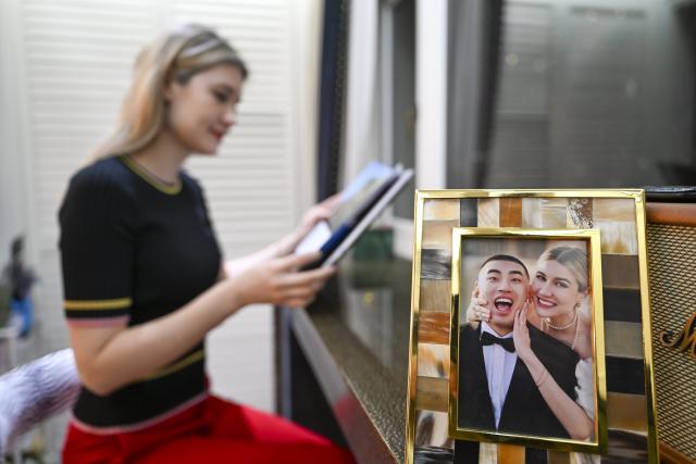 (260216) -- SHANGHAI, Feb. 16, 2026 (Xinhua) -- Aleksandra Antonenko reads a book at home in Shanghai, east China, Feb. 6, 2026.
  Aleksandra Antonenko moved from Russia to pursue her doctorate at Shanghai Jiao Tong University in 2022. She also began to show the charm of everyday life in China to the world with short video clips. 
  In the same year, she met Zhao Yiwei, now her husband, at a coffee shop. Zhao always encourages and supports her diligence, be it in academic pursue or in vlog production.
  With the Spring Festival around the corner, Aleksandra loves wandering through streets and picking out New Year goods. Back to her home, she adds her own tradition to the celebration by cooking Russian dishes for the holiday, turning the table into a blend of two cultures. 
  "The Spring Festival has deep cultural roots," Aleksandra said. "It's a time to bring family together and feel closer."
  Looking ahead, she plans to keep working toward her doctoral degree while continuing to document her life in China through videos. "Every day here brings something new," she said. "I'm excited to share real stories about China with the world."
  From a newbie international student to a Chinese daughter-in-law and a builder of cultural connections, Aleksandra's story reflects a simple belief: love knows no borders. (Xinhua/Chen Haoming)