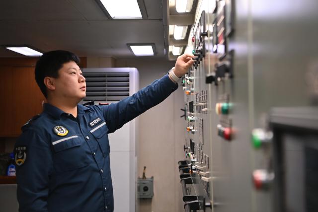 (260216) -- SOUTH CHINA SEA, Feb. 16, 2026 (Xinhua) -- Law enforcer Liu Chunyu operates a power distribution board aboard the China Coast Guard (CCG) vessel Wanshan in the territorial waters of China's Huangyan Dao on Feb. 12, 2026.
  Law enforcers aboard the China Coast Guard (CCG) vessel Wanshan remain on duty during this year's Spring Festival, a most cherished moment for family reunions in China. (Photo by Zhai Yifan/Xinhua)