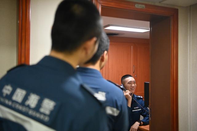 (260216) -- SOUTH CHINA SEA, Feb. 16, 2026 (Xinhua) -- Law enforcers queue up to call their loved ones for Spring Festival greetings aboard the China Coast Guard (CCG) vessel Wanshan in the territorial waters of China's Huangyan Dao on Feb. 12, 2026.
  Law enforcers aboard the China Coast Guard (CCG) vessel Wanshan remain on duty during this year's Spring Festival, a most cherished moment for family reunions in China. (Photo by Zhai Yifan/Xinhua)